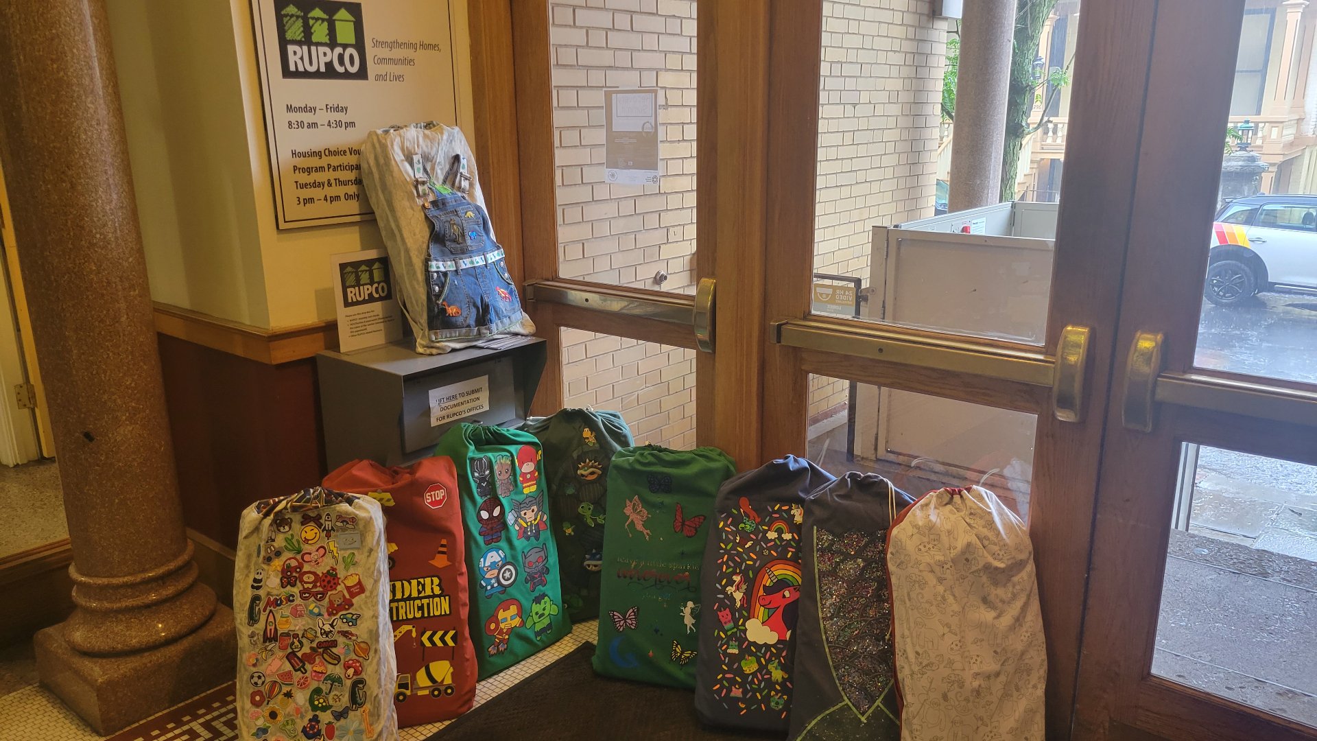 A row of completed MySleeper bags lined up at a community office for distribution.